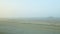 Panoramic view from window airplane rides by empty runway against fields in fog