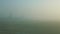 Panoramic view from window airplane rides by empty runway against fields in fog