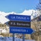 Panoramic view of the winter alps mountain Valle d`Aosta with street signs to major ski resorts in the area