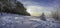 Panoramic view of winter landscape. Covered in snow trees against dramatic evening light. Snowy Baltic sea coast