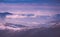 Panoramic view of winter mountains at sunrise. Landscape with foggy hills and trees covered with rime.