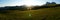 Panoramic view of wonderful sunrise in the mountains on an alp