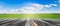 Panoramic view of wooden table top with fresh green field and blue sky in summer. Space for present a product.