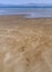 Panoramic views of the sandy beach, the mountains and footprints in the sand at low tide on Liani Ammos beach in Halkida, Greece o