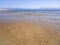 Panoramic views of the sandy beach,  mountains  the island of Evia on Liani Ammos beach in Halkida, Greece on a Sunny summer day