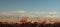 panoramic views of tall port shipping cranes standing tall loading a ship in port with shipping containers at Port Melbourne, with