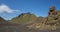 Panoramic volcanic desert landscape with lava rock formation and green Hattafell mountain with footpath of Laugavegur trail.