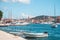 Panoramic waterfront view of the seaside of Starigrad, Hvar. Old boats in the front docked, houses and the famous church belltower
