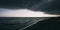 Panoramic widescreen view on the deep blue sea or ocean with dramatic toning on sunset. Big black hurricane clouds