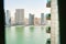 Panoramic window view to high buildings with balconies and marina in Sharjah district. Rented apartment stunning views and real