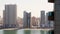 Panoramic window view to high buildings with balconies and marina in Sharjah district. Rented apartment stunning views and real