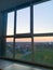 Panoramic windows overlooking beautiful golden sunset. View from home window