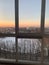 Panoramic windows overlooking beautiful golden sunset. View from home window