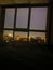 Panoramic windows overlooking beautiful golden sunset. View from home window