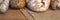 Panoramic wooden kitchen top with bread and rolls on a jute bag