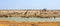 Panormaic view of a waterhole full of many different animals - an amazing sight