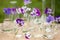 Pansy flowers in chemical glassware, table decoration in garden