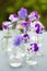 Pansy flowers in chemical glassware, table decoration in garden