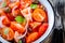 Panzanella: Italian salad with tomatoes, ciabatta, olives, red onion and basil closeup