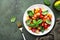 Panzanella summer vegetable salad with stale bread, colorful tomatoes, olive oil, salt and green basil, green table background,