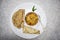 Papad ki sabji in a bowl served with roti and rolled pappadam and green chilly in plate bowl spoon. Traditional indian meal for