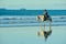 Papamoa Beach, Papamoa, New Zealand â€“ July 07, 2019: an unidentified woman on a white horse at a seashore.