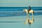 Papamoa Beach, Papamoa, New Zealand ÃƒÂ¢Ã¢â€šÂ¬Ã¢â‚¬Å“ July 07, 2019: an unidentified woman on a white horse at a seashore.