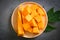 Papaya fruits on dark backgroud, fresh ripe papaya slice on plate tropical fruit with leaf leaves from papaya tree