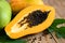 Papaya fruits on wooden backgroud, fresh ripe papaya tropical fruit with papaya seed and leaf leaves from papaya tree