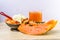 Papaya, juice and ice cream for desert on wooden background.