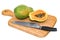 Papaya lies on a wooden board next to a knife, 3D rendering