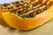 Papaya slice with seeds on the wooden background