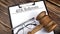 Paper with 401k Rollovers with gavel, pen and glasses on the wooden background