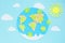 paper application: planet earth, continents, clouds, sun and green viruses around on a blue background. Coronavirus pandemic