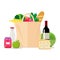 Paper bag with food. Shopping at the supermarket or grocery store. A set of healthy food. Vegetables and fruits, wine