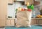 Paper bag full variety of useful food on wooden table