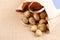 A paper bag with potatoes diagonally in a frame on a table covered with a cloth