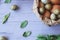 Paper bag with quail and compartment eggs on a gray wooden background