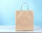 Paper bag on table blue background.Shopping and business