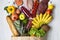 Paper bag of various healthy products on white wooden background, closeup. Health food. Flat lay. Top view.