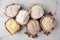 Paper bags with different types of flour and ingredients on white marble table, flat lay