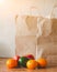 Paper bags, fresh vegetables and fruits next to a mobile phone on the table with kitchen utensil. Concept of shopping, healthy