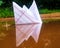 Paper boat in water and water reflection