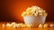 Paper box with popcorn on orange and copy space horizontal web banner Cinema and movie fast food