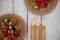 Paper cardboard dishes with vegetable salad tomatoes cucumbers with wooden devices fork knife horse