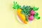 Paper carrot, radish and parsley on paper plate