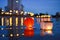 Paper Chinese lanterns floating in river with city lights reflections