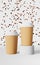 Paper coffee cup white lid falling beans 3D rendering. Coffee shop discount demonstration podium. Hot drinks sale banner