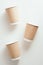 Paper coffee cups set on white background. Flat lay, top view hot drink containers