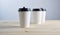 Paper coffee disposable cup for take away or to go, wooden table, space for design mock-up